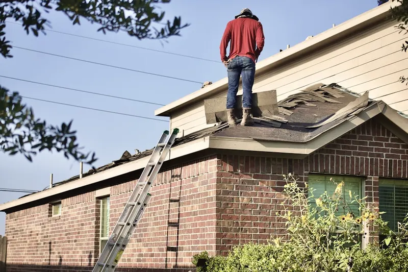 Professional roofer working on a residential roof in Crawfordville